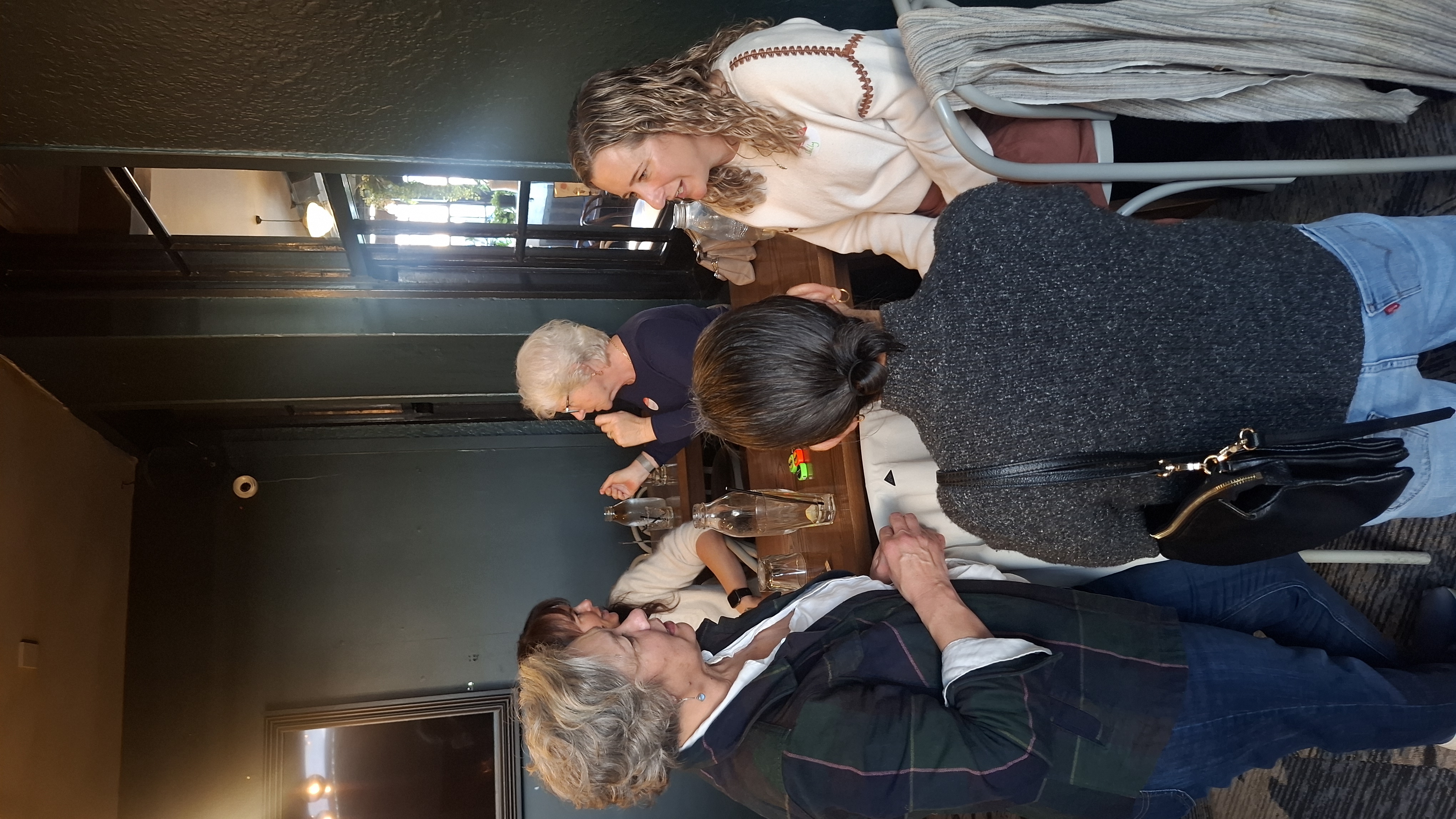 Guests in conversation around a table at the event