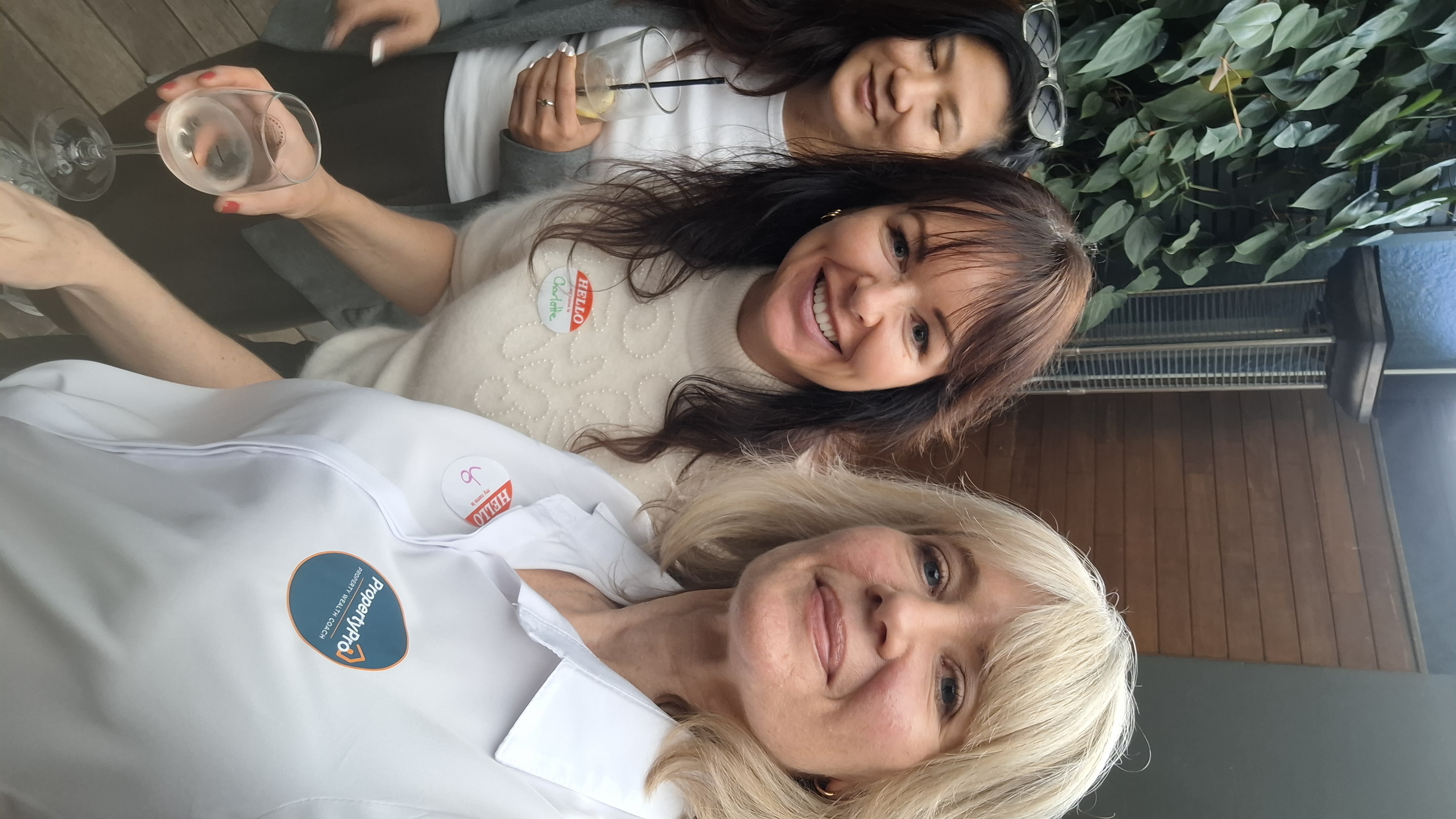 Attendees smiling together with name badges at the welcome