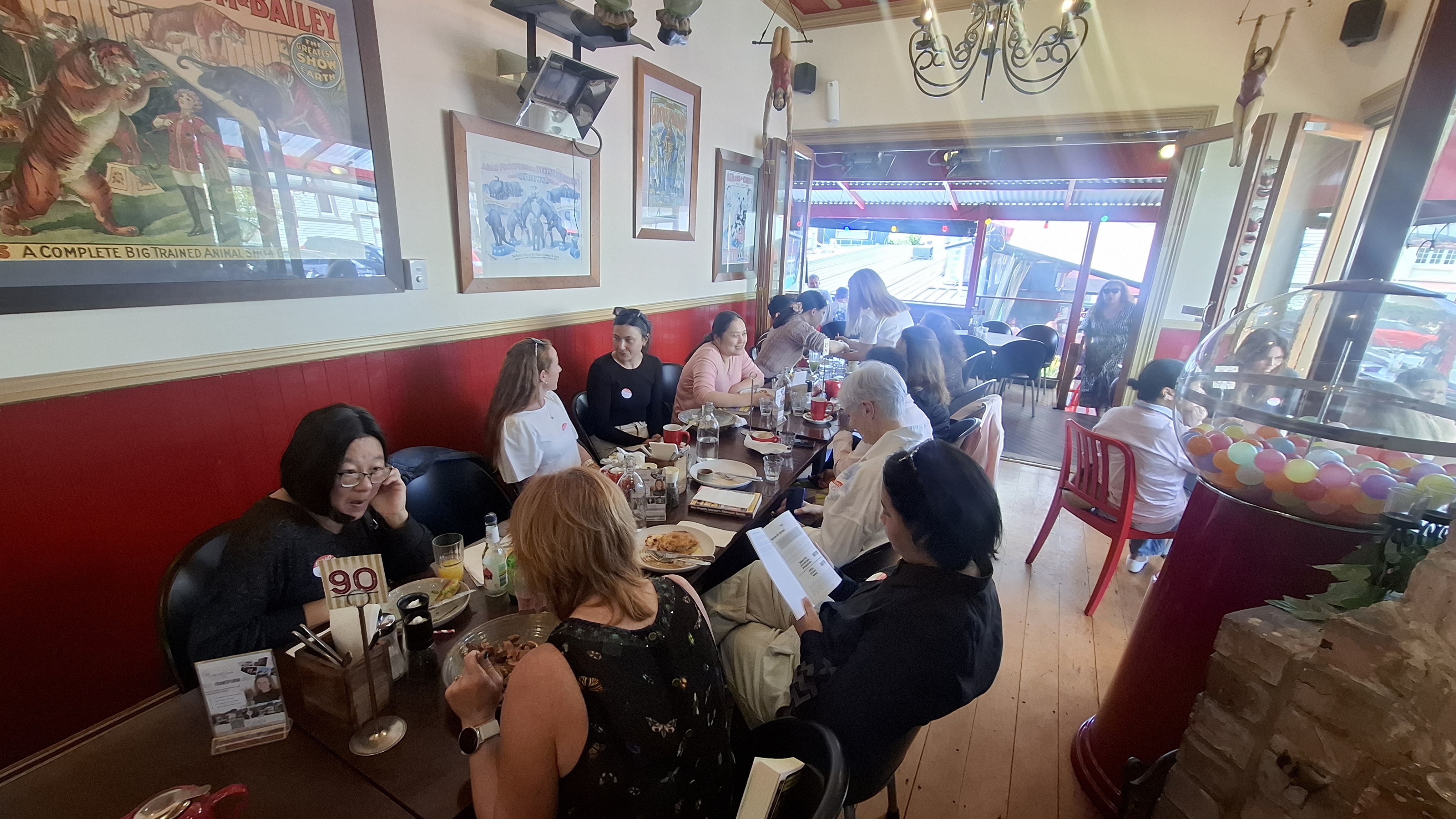 Guests chatting over lunch beneath vintage circus posters