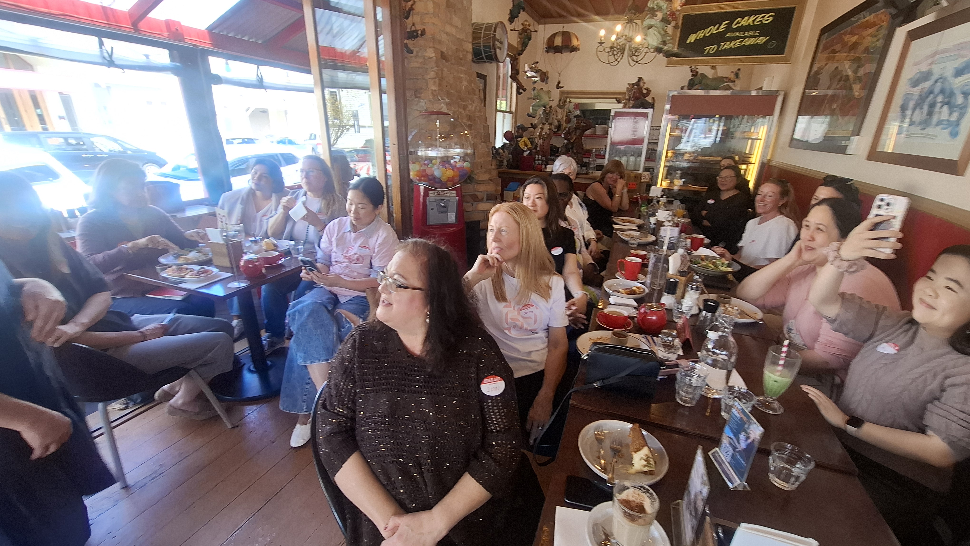 Attendees seated along the long table at Circus Circus, Mt Eden, listening to the speaker