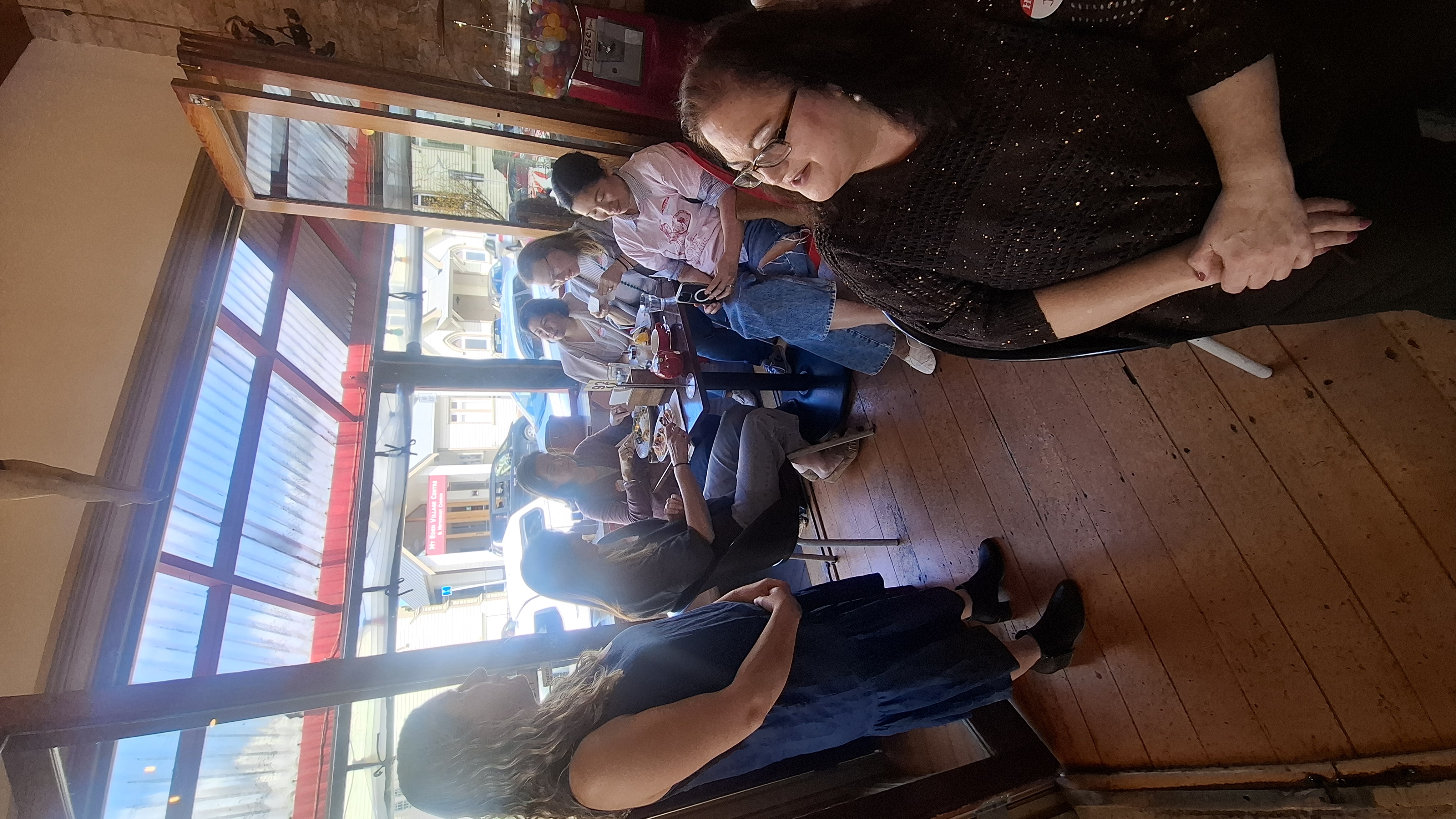 Guests at the window table with Mt Eden Village Centre visible outside